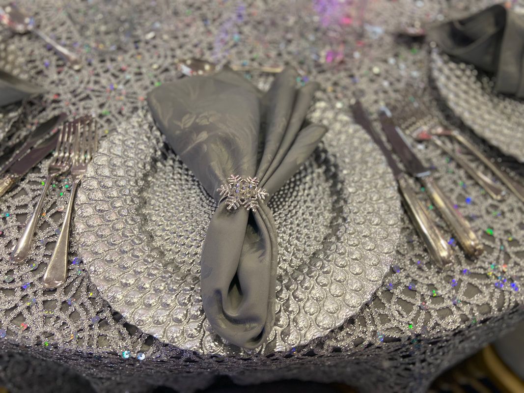 Silver charger plate on silver table cloth